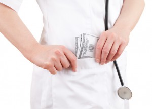 bribe in medicine - doctor taking a lot of dollars to workwear pocket, white background