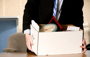 Fired office worker picking up his belongings