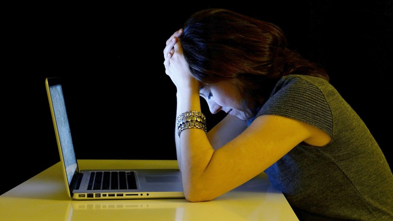 Young student woman alone with computer crying sad depressed