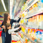 Mother and daughter buying in supermarket