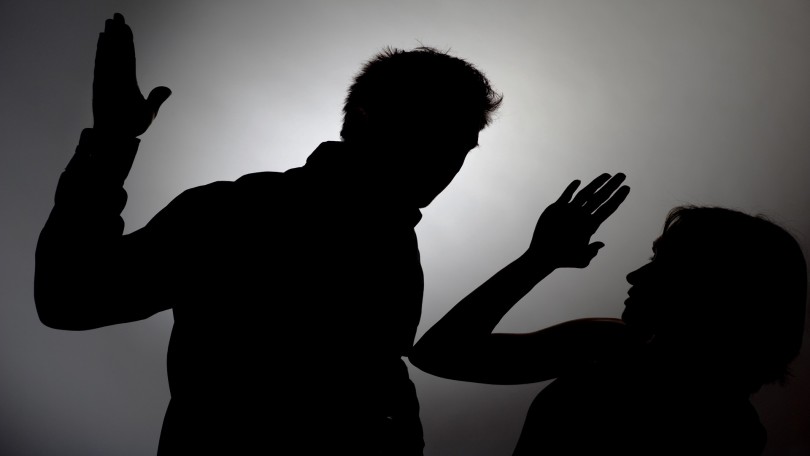 Man beating woman, silhouette