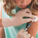 Vaccination Concept. Girl Receiving Measles Vaccine In Clinic, Copy Space